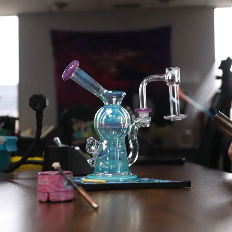 Blue glass rig on a table with vapor